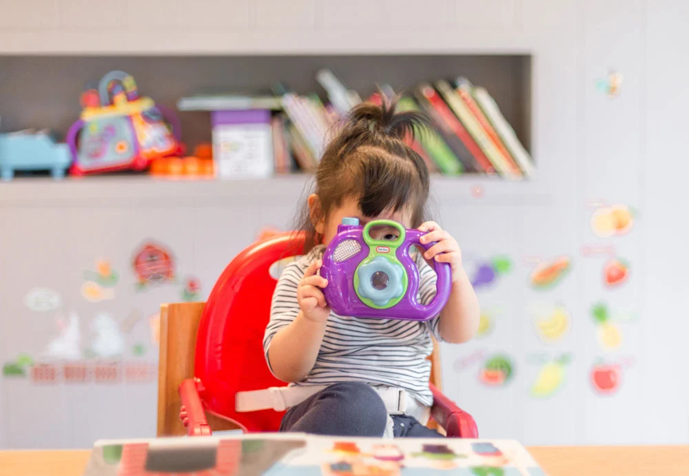 An autistic girl joyfully engaged in play at the Collaboration Station Autism Center's educational facility. She explores learning through interactive activities, embodying a supportive and inclusive environment for children on the autism spectrum through ABA Therapy